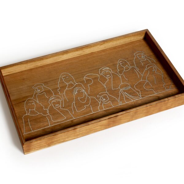 alt="Wood veneer tray with drawn faces and figures"