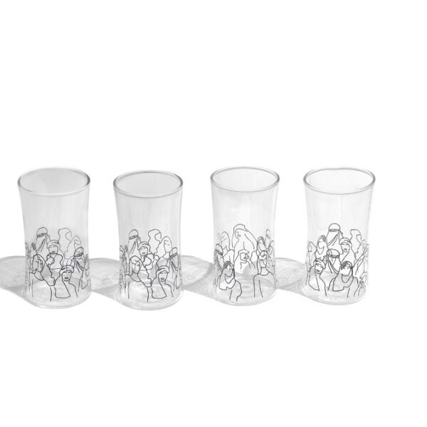 double glass water cups with black faces and figures"