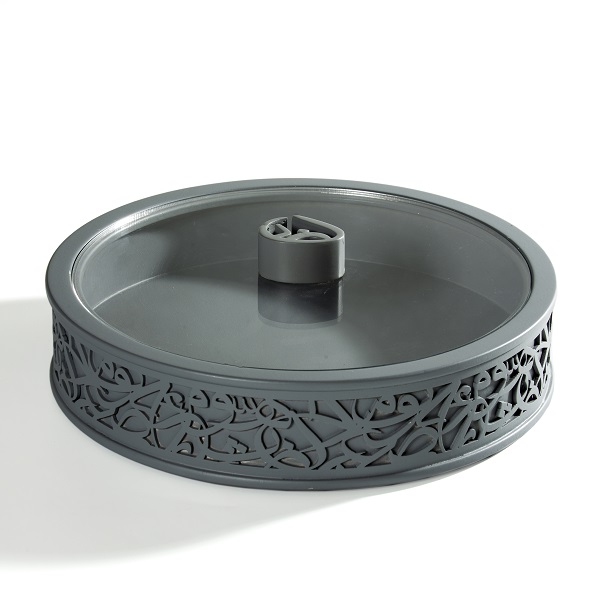 alt="round grey box with arabic letters and clear plexi lid"