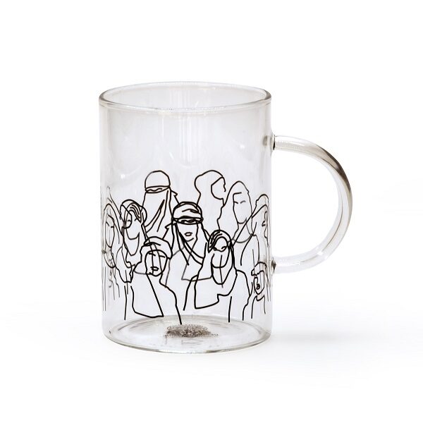alt="clear glass mug with drawings of people"