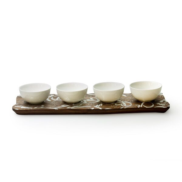 alt="white porcelain bowls with wood and mother of pearl base"