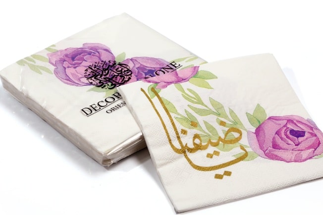 Printed napkins, with pink peony flower print and golden-print Arabic calligraphy "Ya Daifana" - Meaning "Our Guest". Napkin size 30x30cm when open, 3ply tissue, 20 napkins per pack.