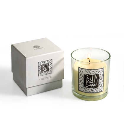 A glass candle with a sticker written on it "Al Omor Al Salem" - Meaning "A Healthy Life" has an amber lily scent, and comes with a white gift box.