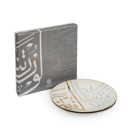 alt="caligraphy dinner plates with gold and silver writing"