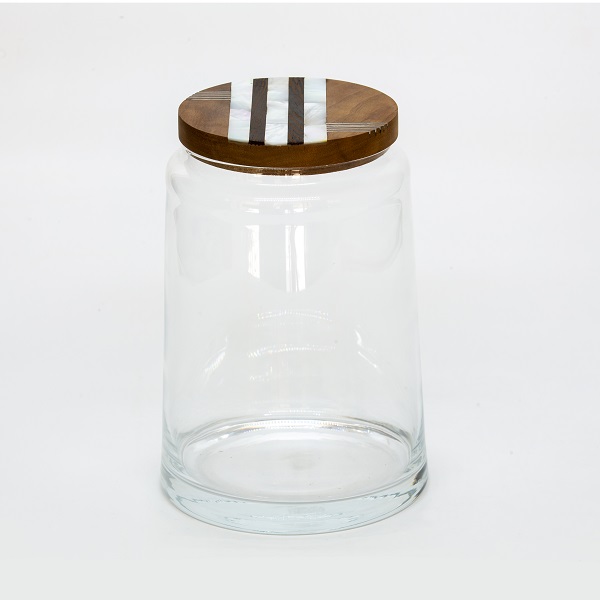 alt="clear jar with wood and mother of pearl lid"
