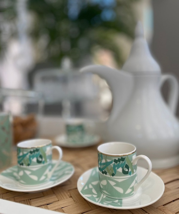 alt="porcelain turkish coffee cups with arabic calligraphy in green"