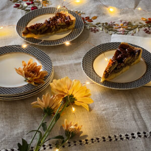 A delicious-looking slice of pie, served on a white plate with a decorative fork. From decoration
